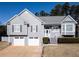 Charming two-story home with a two-car garage, landscaping, and a welcoming front entrance at 1103 Etowah Valley Ln, Woodstock, GA 30189