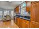 Kitchen with wood cabinets, black countertops, stainless steel appliances, and eat-in area at 1103 Etowah Valley Ln, Woodstock, GA 30189