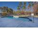 Kidney-shaped pool with concrete surround and metal fencing at 1103 Etowah Valley Ln, Woodstock, GA 30189