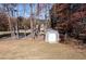 Backyard with storage shed and fenced area, surrounded by trees at 1103 Etowah Valley Ln, Woodstock, GA 30189