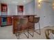 Basement wet bar with dark wood cabinetry, beverage cooler, and bar seating at 1103 Etowah Valley Ln, Woodstock, GA 30189