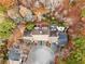 Aerial view of home showcasing a private circular driveway and wooded setting at 9015 Niblick Dr, Alpharetta, GA 30022