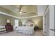 Large bedroom with king bed, tray ceiling, and ample natural light at 9015 Niblick Dr, Alpharetta, GA 30022