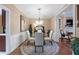 Elegant dining room with a round glass table and four white chairs at 9015 Niblick Dr, Alpharetta, GA 30022