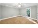 Bright bedroom with large window, neutral gray walls, and plush carpet at 2784 Sixes Rd, Canton, GA 30114