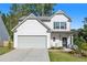 Two-story house with gray siding, gray driveway, and landscaped lawn at 605 Edgemore Rd, Canton, GA 30114