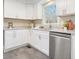 Bright white kitchen boasts stainless steel appliances, granite counters, and ample cabinet space at 2638 Foxglove Sw Dr, Marietta, GA 30064