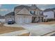 Two-story brick home with a three-car garage and landscaped front yard at 96 Wentworth Cir, Villa Rica, GA 30180