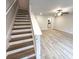 Spacious living room with light gray vinyl flooring and ceiling fan at 7240 Crestside Dr # 78, Austell, GA 30168