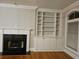 Fireplace and built-in bookshelves in living room with hardwood floors at 4835 Abberley Ln, Alpharetta, GA 30022