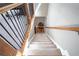 Aerial view of a carpeted staircase with hardwood handrail and metal balusters at 4835 Abberley Ln, Alpharetta, GA 30022