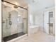 Luxurious primary bathroom with tiled glass shower, freestanding tub, and unique wall design at 4045 Hosch Retreat Drive, Buford, GA 30519