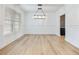 Bright dining room with hardwood floors and a modern chandelier at 4045 Hosch Retreat Drive, Buford, GA 30519