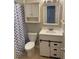 Updated bathroom with a vanity, toilet, shower, and checkered shower curtain at 1166 Booth Sw Rd # 610, Marietta, GA 30008