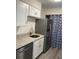 Bright, galley-style kitchen with white cabinetry, stainless steel appliances, and granite countertops at 1166 Booth Sw Rd # 610, Marietta, GA 30008