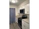 Compact kitchen equipped with stainless steel appliances, white shaker cabinets, and granite countertops at 1166 Booth Sw Rd # 610, Marietta, GA 30008