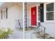 Welcoming front porch with a bright red door, black shutters, and decorative wrought iron railing at 212 Normandy Sw Dr, Marietta, GA 30064