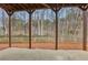 View of the backyard from under the deck, featuring a wooden fence and trees at 1961 Enchanted Woods Trl, Marietta, GA 30066