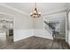 Dining room with a chandelier, wainscoting, and an adjacent staircase at 1961 Enchanted Woods Trl, Marietta, GA 30066