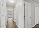 Hallway with hardwood floors and white doors leading to other rooms at 1961 Enchanted Woods Trl, Marietta, GA 30066