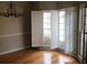 Dining room with hardwood floors, large windows, and white shutters at 209 Cobblestone Cv, Sharpsburg, GA 30277