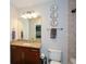 Guest bathroom with granite countertop, vanity, tiled shower, and decorative wall plates at 855 Peachtree Ne St # 2412, Atlanta, GA 30308