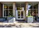 Modern building entrance with glass doors and planters at 855 Peachtree Ne St # 2412, Atlanta, GA 30308