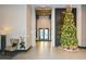 Elegant lobby with festive holiday decorations, comfortable seating, and access to elevators at 855 Peachtree Ne St # 2412, Atlanta, GA 30308