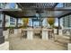 Outdoor kitchen with grill, sink, bar seating, and covered pergola at 855 Peachtree Ne St # 2412, Atlanta, GA 30308