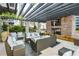Relaxing outdoor lounge area with comfortable seating, fireplace, and pergola at 855 Peachtree Ne St # 2412, Atlanta, GA 30308