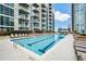Large rectangular pool with surrounding lounge chairs at 855 Peachtree Ne St # 2412, Atlanta, GA 30308