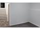 Empty bedroom with gray carpet and a view of the stairs at 4229 Castle Gate Dr, Snellville, GA 30039