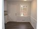 Dining room with gray flooring, white door, and window view at 4229 Castle Gate Dr, Snellville, GA 30039