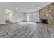 Open living area with gray floors and a large stone fireplace at 851 Forest Path, Stone Mountain, GA 30088