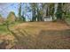 Spacious, sloped backyard with storage building and shade trees at 2649 Toni Sw Pl, Marietta, GA 30060