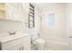 White bathroom with shower/tub combo, white vanity, and frosted window at 2649 Toni Sw Pl, Marietta, GA 30060