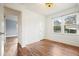 Bright, empty bedroom with hardwood floors, white walls, and large windows at 2649 Toni Sw Pl, Marietta, GA 30060