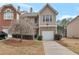 Two-story townhome with attached garage and landscaping at 70 Oak Green Dr, Lawrenceville, GA 30044