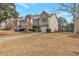 Townhome with driveway and grassy yard at 70 Oak Green Dr, Lawrenceville, GA 30044