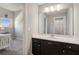 Well-lit bathroom boasts a vanity with dark brown cabinets and a large mirror at 5705 Windjammer Pt, Cumming, GA 30041