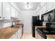 Modern kitchen with white cabinets, dark appliances, and subway tile backsplash at 3160 Seven Pines Ct # 301, Atlanta, GA 30339