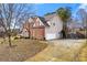 Side exterior view of a two-story brick home with driveway and attached garage at 4894 Brown Leaf Dr, Powder Springs, GA 30127