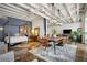 Open-concept dining area with a wooden table, modern chairs, and view of the bedroom at 805 Peachtree Ne St # 307, Atlanta, GA 30308