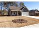 Front yard of a single-story home with blue siding, a covered porch, and a two-car garage at 318 Forkview Dr, Lawrenceville, GA 30044