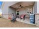 Spacious covered porch with sitting area, outdoor kitchen, and fire pit at 3934 Saddle Bag Ct, Dacula, GA 30019