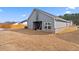 Exterior of single-Gathering home with covered back patio, fenced yard, and grassy lawn at 3934 Saddle Bag Ct, Dacula, GA 30019