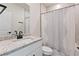 Clean bathroom featuring white vanity, granite countertop, and patterned shower curtain at 3934 Saddle Bag Ct, Dacula, GA 30019