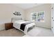 Bright bedroom with natural light, metal-framed bed, and plush carpeting at 3934 Saddle Bag Ct, Dacula, GA 30019