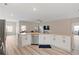 Open-concept kitchen with a large island, stainless steel appliances, and white cabinetry at 3934 Saddle Bag Ct, Dacula, GA 30019