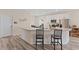 Modern kitchen with white cabinetry, granite countertops, and a breakfast bar at 3934 Saddle Bag Ct, Dacula, GA 30019